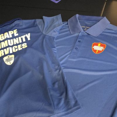 Blue AGAPE Community Services shirts with logos, professional appearance.